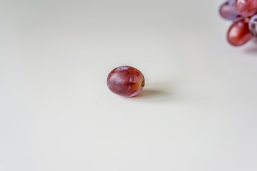 Close-up of grapes on a white background. Dessert grape with a sweet taste, without seeds.