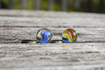 a pair of marbles on a wood table