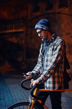 Young  man cheking his phone at the street at night