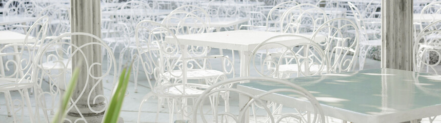 white tables and chairs in cafe outdoor