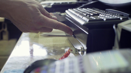 Man's hand closing cash box