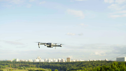 Fototapeta premium A drone quadrocopter with camera flying in the sky