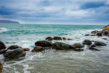 Fototapeta na wymiar Seascape with the strong wave hitting rocks