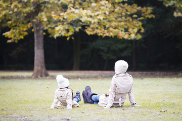 Mother and daughter playing in autumn park