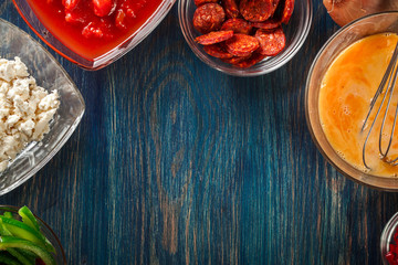 Ingredients for preparing frittata - eggs, sausage chorizo, red