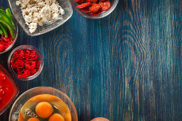 Ingredients for preparing frittata - eggs, sausage chorizo, red