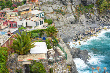 View to a restaurant terrace, sea and mountains of Vernazza, Cinque Terre, Italy