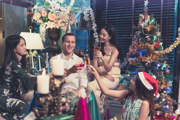 Group Of Friends Enjoying Christmas Drinks In Bar Celebrating x mas at home
