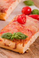 Italian pizza with cheese, tomatoes and fresh basil.