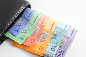 Black Wallet with Malaysia ringgit bank notes isolated on white background