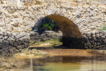 Fototapeta na wymiar Historic rock bridge in Cascais
