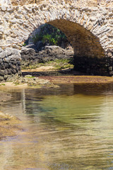 Fototapeta na wymiar Historic rock bridge in Cascais