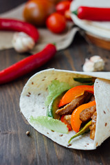 Mexican vegetarian food - fajitas wrapped on tortilla bread.