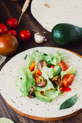 Natural vegetarian mexican food - fresh salad on tortilla bread.