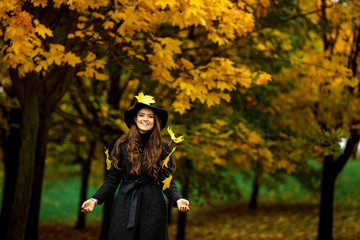 Fototapeta na wymiar woman with autumn leaves in hand and fall yellow maple garden background