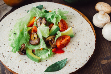 Natural vegetarian mexican food - fresh salad on tortilla bread.