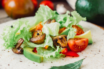 Natural vegetarian mexican food - fresh salad on tortilla bread.