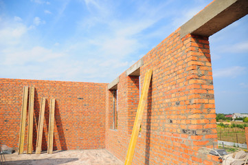 Unfinished brick house construction. Building new brick house with concrete lintel and with...