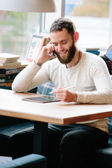 Man using tablet pc with a pencil at a desk