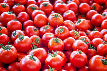 Red tomato fruits, top view, background and texture