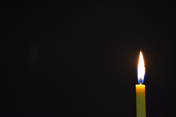 Candle light with dark background.