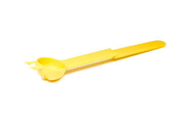 Close up unusual yellow plastic spoon isolated