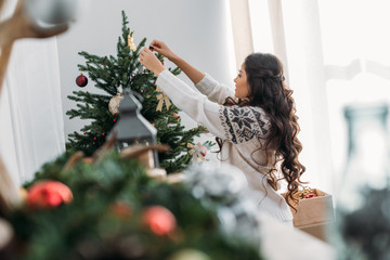 woman decorating christmas tree