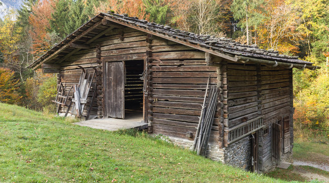Historical barn in the alps, autumn colors, open door