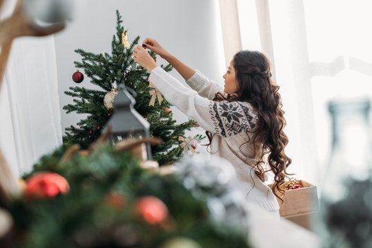 Woman Decorating Christmas Tree