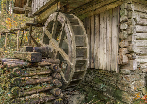 Historical water mill in bavaria with water wheel.