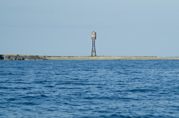 Fototapeta premium Wooden lighthouse on the coast of the Barents Sea