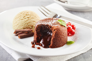Lava cake filled with chocolate on plate