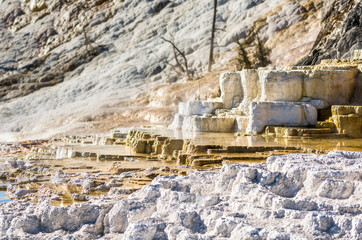 Mammoth hot springs travertine terraces in Yellowstone National Park with steam and step pools