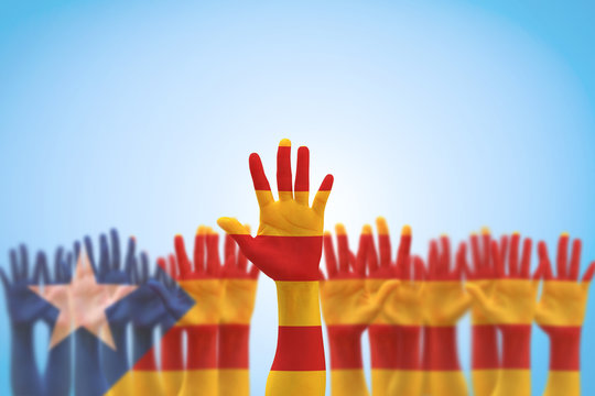 Catalan separatism concept with Senyera estelada (Eastern Catalan) flag on Catalunya people's hand open palms (isolated with clipping path) Catalonia supporters for national independence vote