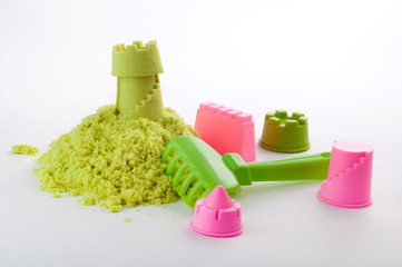 Castle made of kinetic sand on white background