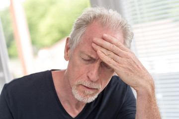 Mature man having a headache