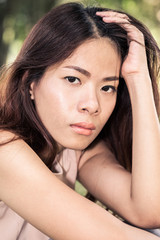 Fototapeta premium Close up beautiful young woman feel sadness. Asia woman. Vintage or retro tone.