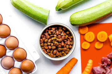Dogfood set with vegetables, eggs and meat on table background t