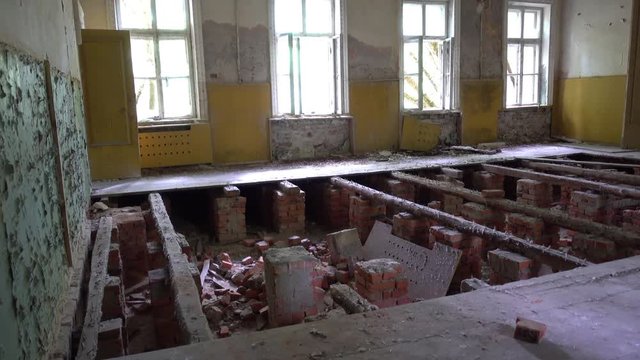 Chernobyl, Ukraine - 17th of June 2017: Visit to Zalesye village in Chernobyl zone - 4K Collapsed floor in the building of cultural center