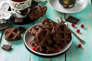 Belgian chocolate wafers with fresh berries and mint on the kitchen wooden table, home healthy breakfast.