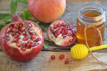 Honey, apple and pomegranate for traditional holiday symbols rosh hashanah jewesh holiday on wooden background