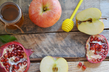 Honey, apple and pomegranate for traditional holiday symbols rosh hashanah jewesh holiday on wooden background