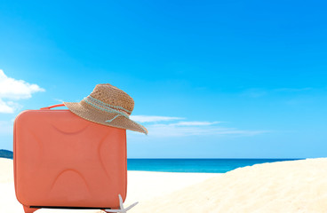 Summer traveling with old suitcase and Fashion woman, fish star, sun glasses, hat. Travel in the holiday, blue sky and beach background.  Summer and Travel Concept.