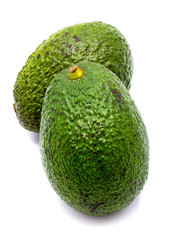 Two whole avocado (Persea americana, alligator pear) isolated on white background
