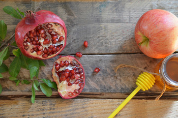 Honey, apple and pomegranate for traditional holiday symbols rosh hashanah (jewesh holiday) on black background