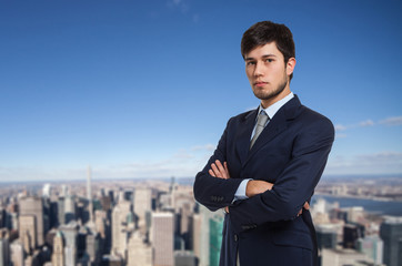 Fototapeta na wymiar Portrait of a young businessman in front of a city