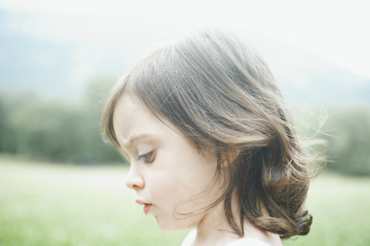 Close up of a cute little girl in a field