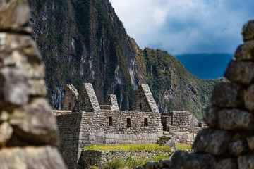 Stonework structure on Machu Picchu with Huayna Picchu in the background.