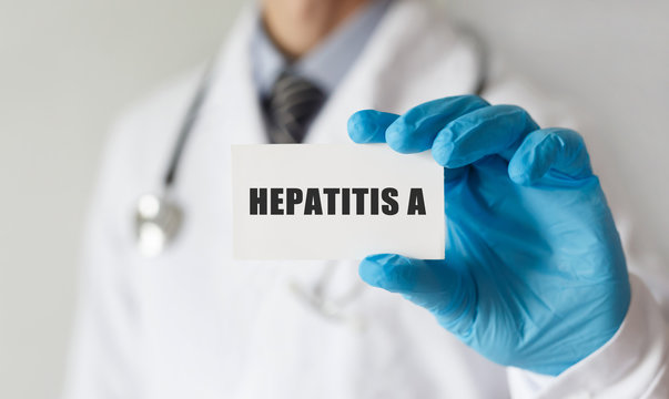 Doctor holding a card with text HEPATITIS A, medical concept