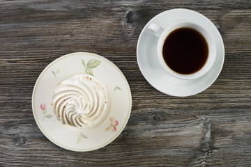 Sweet white meringue and cup of hot tea